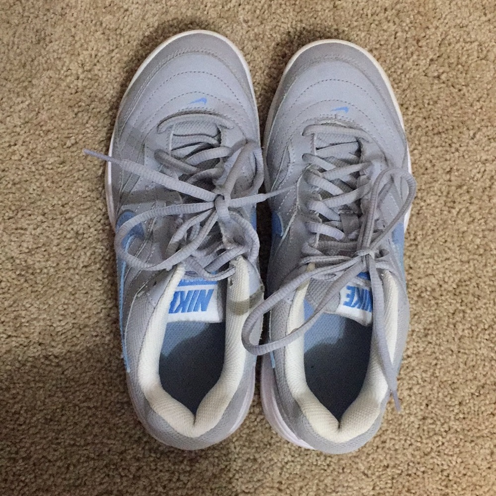 gray and blue nike tennis court playing shoes